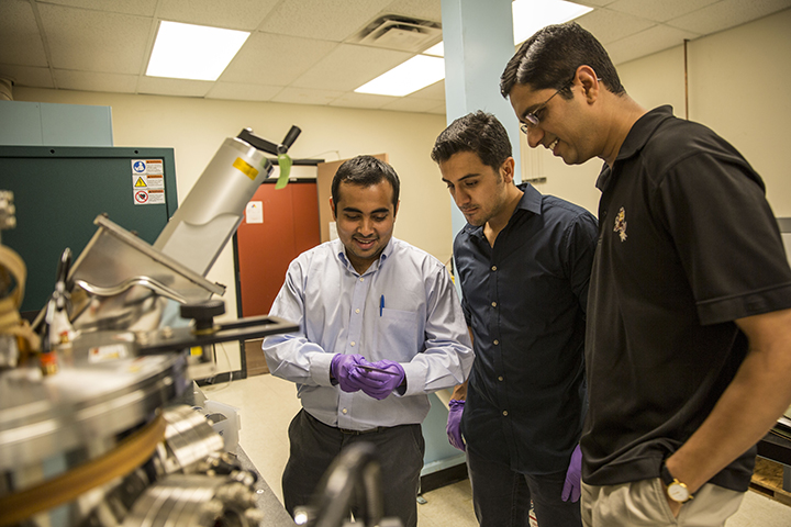 Assistant professor Jagannathan Rajagopalan (at right) is pictured in his Arizona State University laboratory with engineering graduate students Rohit Sarkar (at left) and Ehsan Izadi, who assist with research to better understand the relationship between the microstructure and mechanical behavior of metals and alloys. The National Science Foundation is helping to support Rajagopalan’s project to develop “shape-memory” metal alloys. Photographer: Jessica Hochreiter/ASU