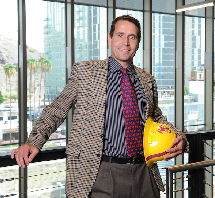 Portrait of David Grau holding an ASU hardhat