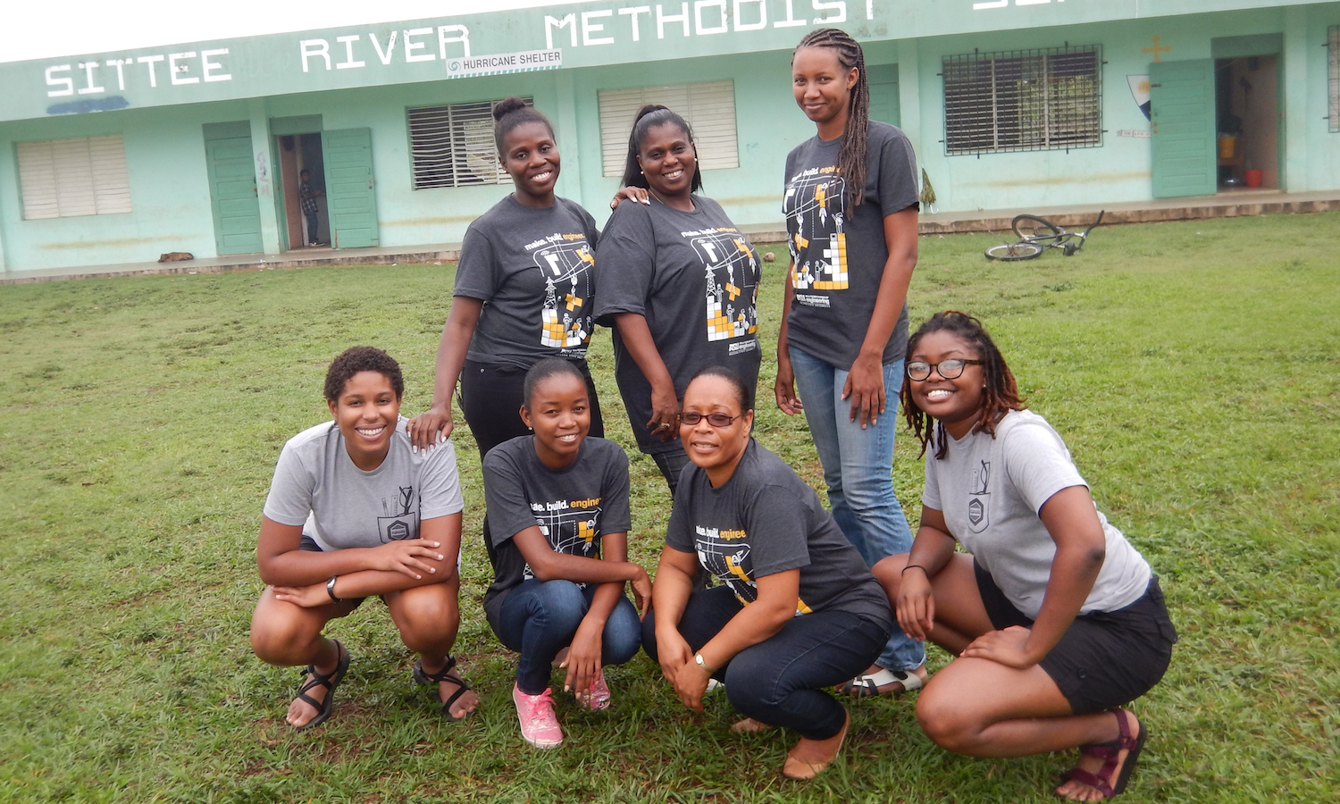 Photo of seven women posing outdoors. Globally Caption: Fulton Schools sustainable engineering doctoral student Evvan Morton (far left) and Shakira Hobbs, an engineering research associate at the University of Virginia (far right), are shown with school teachers in the Belize village of Sittee River. Morton and Hobbs are leaders of a project aimed at helping the remote rural community to adopt renewable energy technology and establish an environmentally safe waste management system. Photo courtesy of Evvan Morton and Shakira Hobbs.