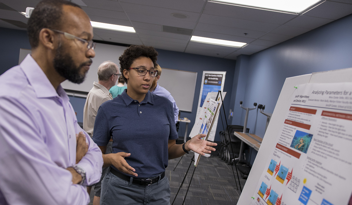 SenSIP-Final-Presentations-2018-MAC0397w two people looking at poster