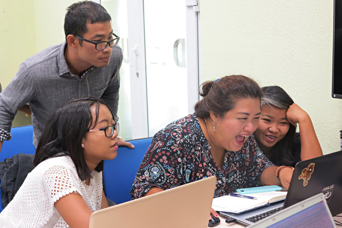 IMG_4475w four people happy looking at a laptop