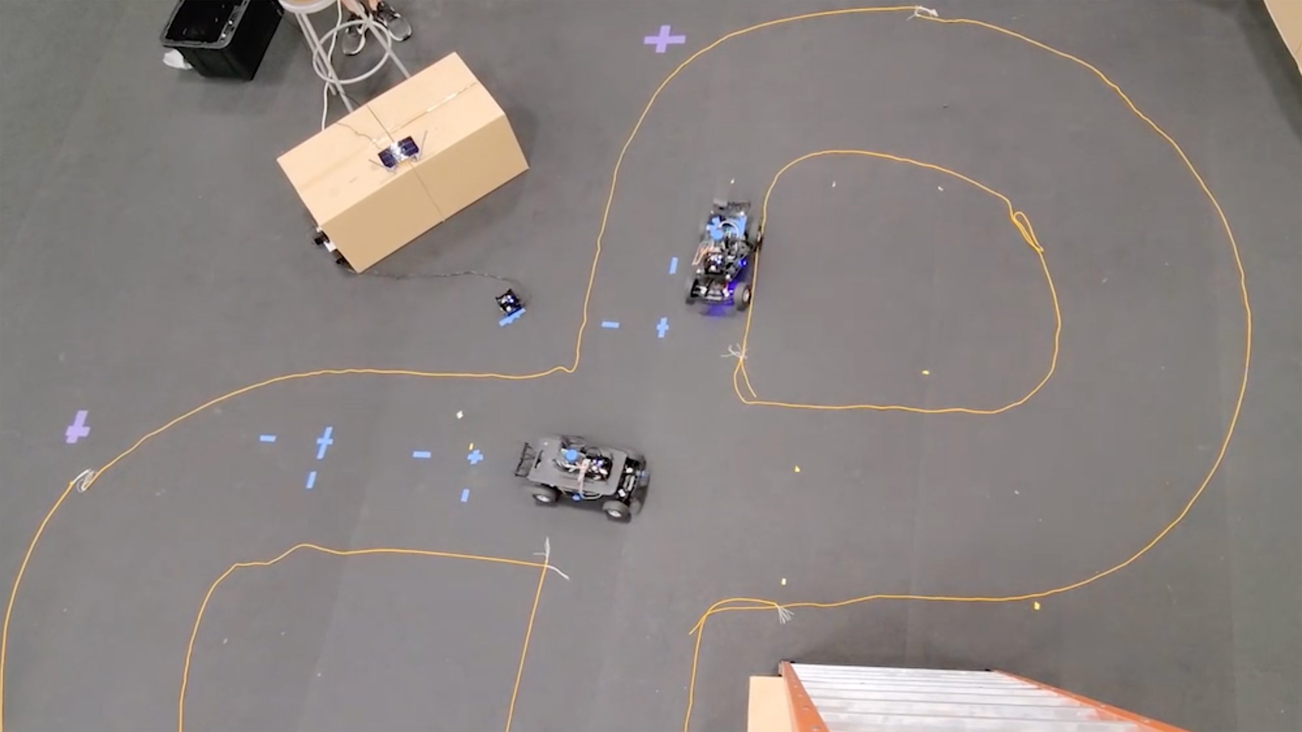 pair of autonmous vehicles driving in a figure-eight track