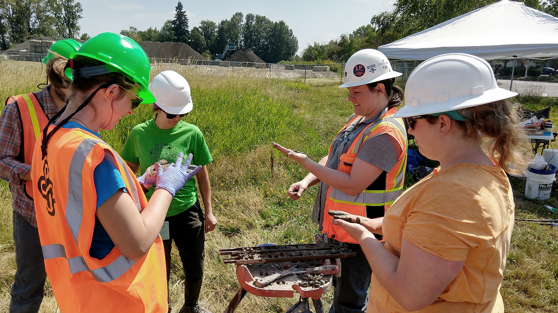A group of students in hard hats working outdoors